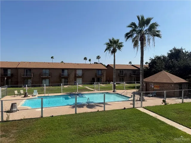 a swimming pool with outdoor seating and yard