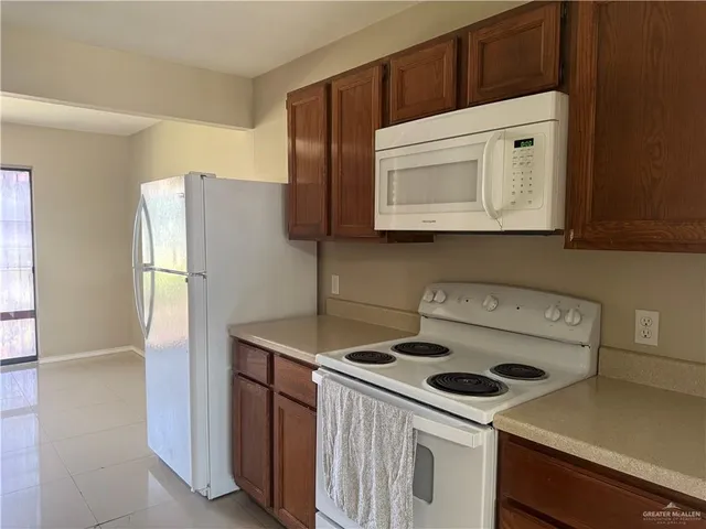 a kitchen with a stove microwave and refrigerator
