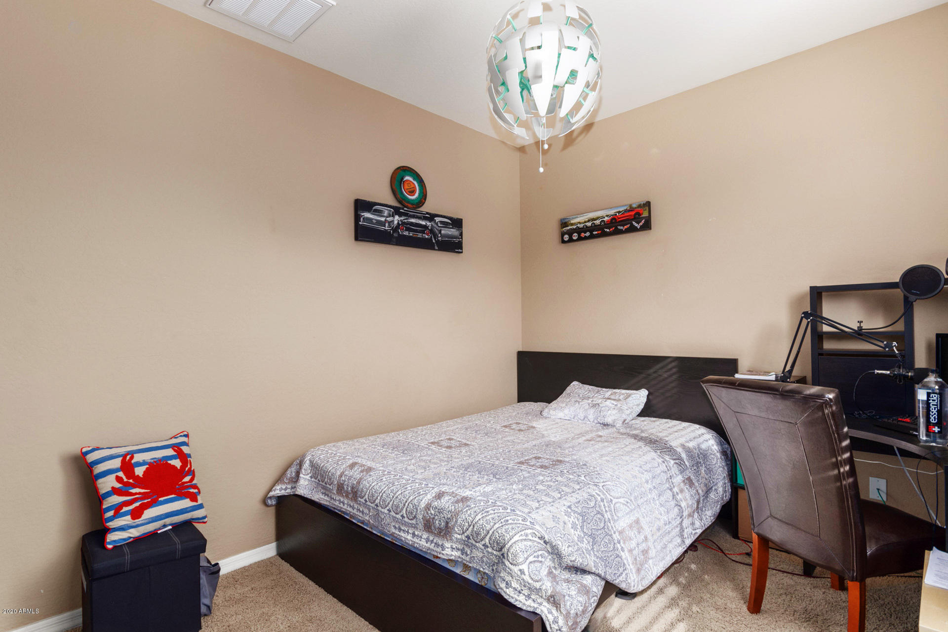 2334 West Beverly Rd. Phoenix, AZ 85041 - Photo 20 of 40 a bedroom with a bed and a chandelier