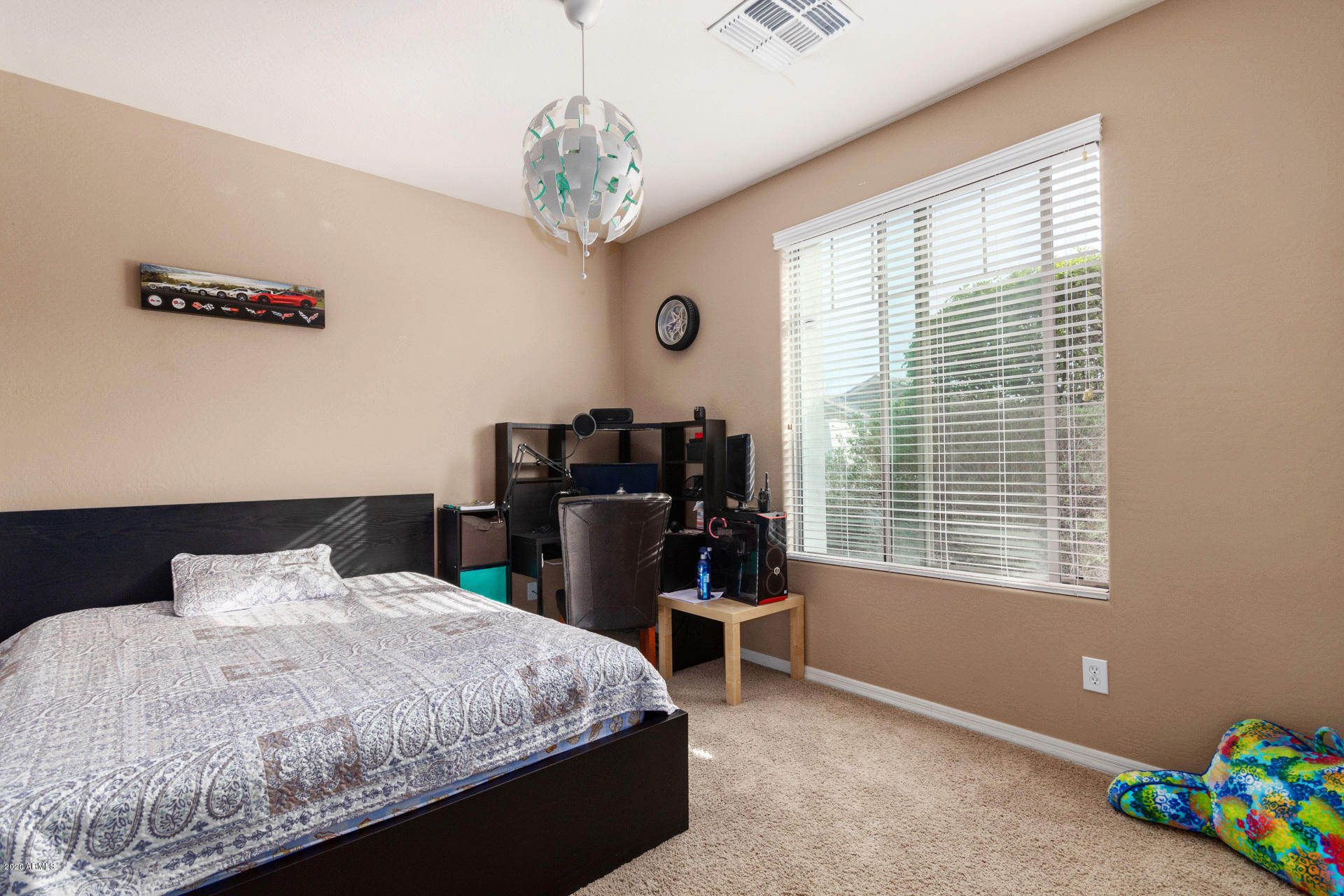 2334 West Beverly Rd. Phoenix, AZ 85041 - Photo 21 of 40 a bedroom with a bed and a chandelier
