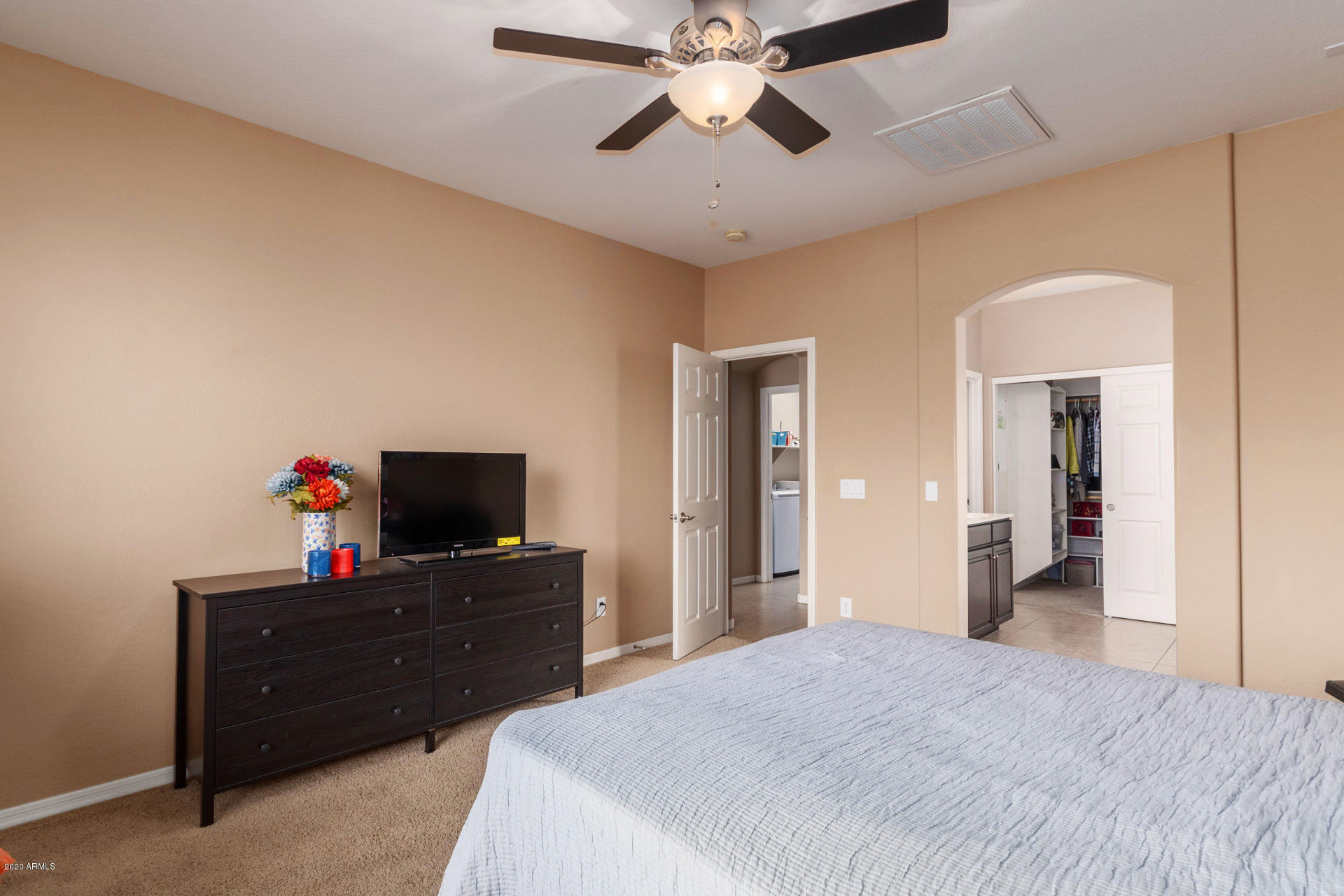 2334 West Beverly Rd. Phoenix, AZ 85041 - Photo 29 of 40 a bedroom with a bed and a flat tv screen on dresser
