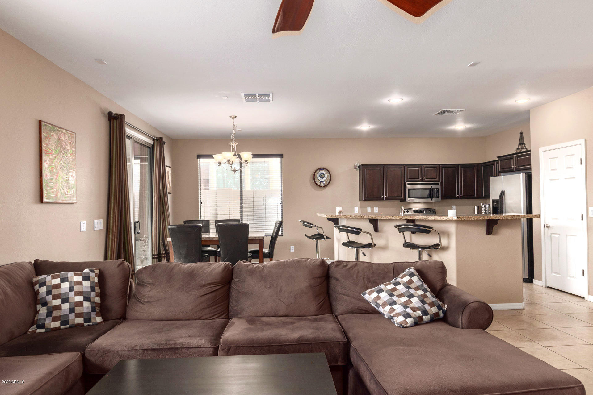 2334 West Beverly Rd. Phoenix, AZ 85041 - Photo 10 of 40 a living room with furniture kitchen view and a large window