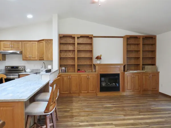 a large kitchen with stainless steel appliances a stove and cabinets