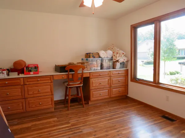 a view of room with wooden floor and cabinet