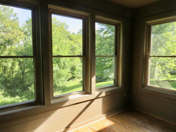 a view of room with wooden floor and cabinet