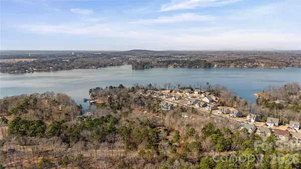 a view of a lake with houses in the back