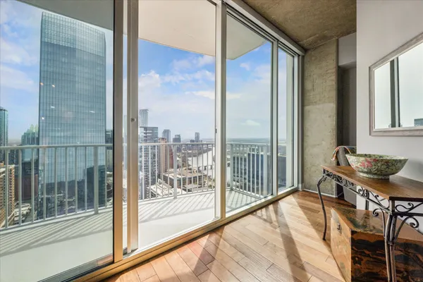 a view of a balcony and chair and floor to ceiling window