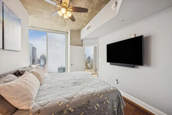 a bedroom with a bed and a flat screen tv