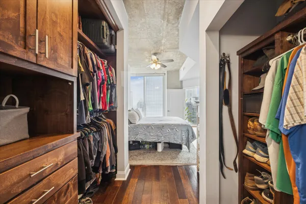 a view of walk in closet with clothes and shoes