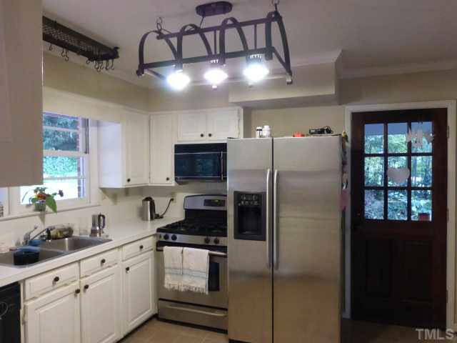 2516 Oxford Road Raleigh, NC 27608 - Photo 18 of 23 The existing kitchen opens through a side door to the carport.