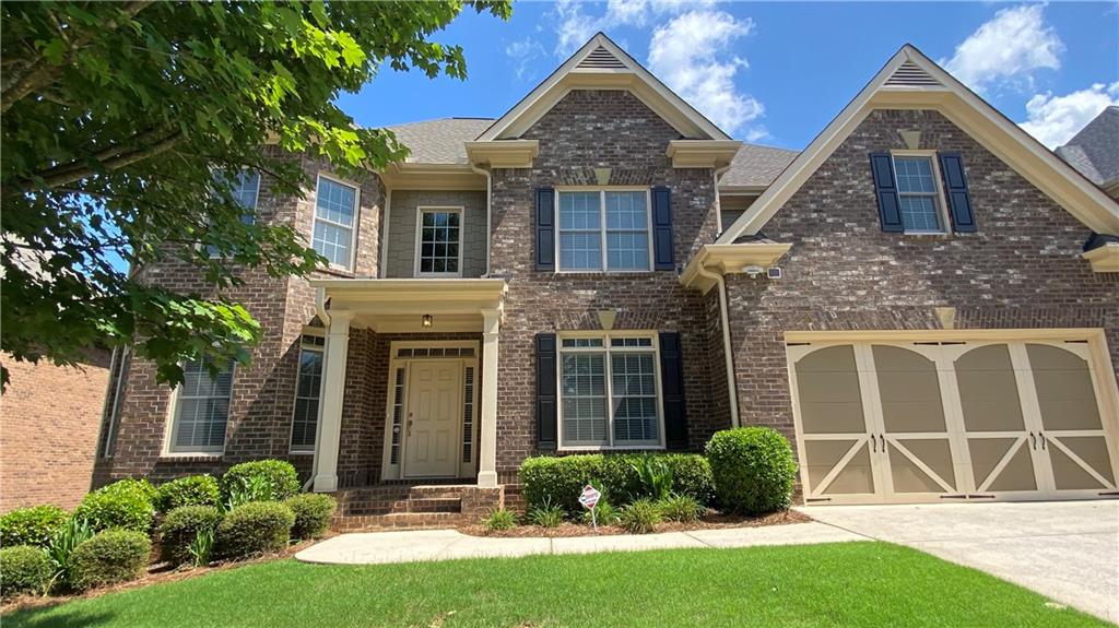 front view of a house with a yard