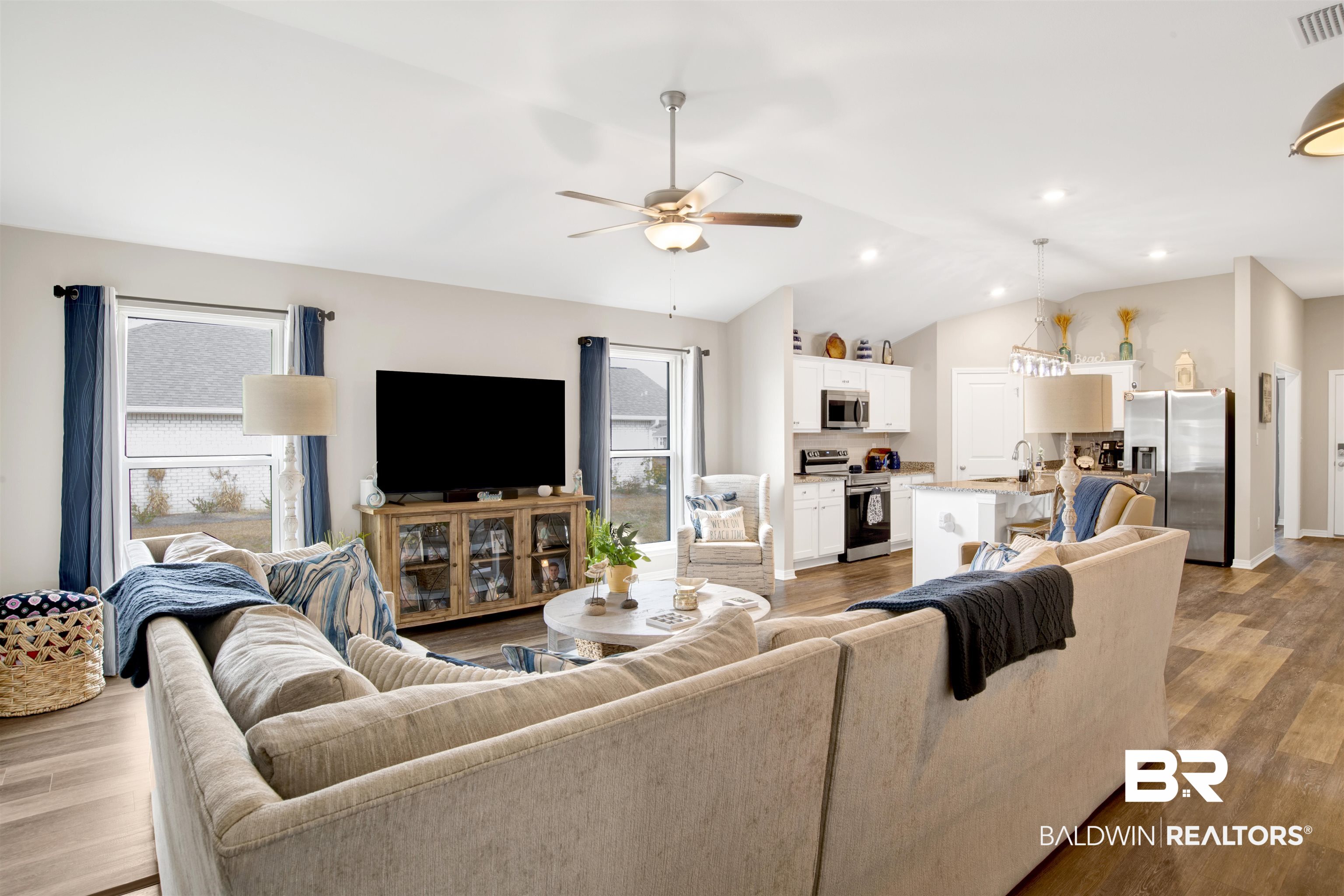 3097 Ingrid Lane Foley, AL 36535 - Photo 11 of 38 Living room with lofted ceiling, sink, light hardwood / wood-style floors, and plenty of natural light