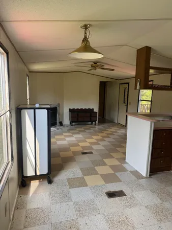 a bathroom with a sink a toilet a mirror and shower