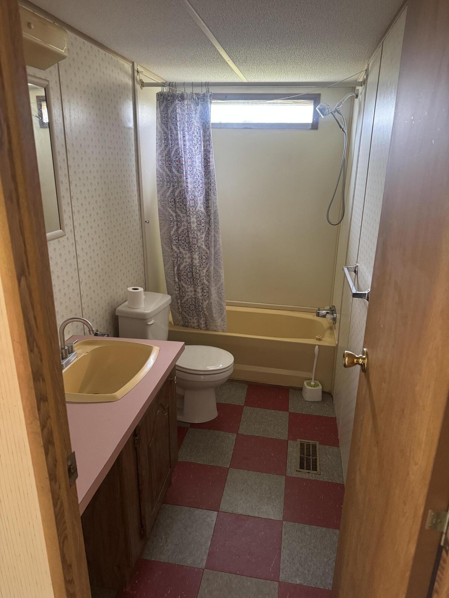 7180 Henry Road Henry, VA 24102 - Photo 8 of 12 a bathroom with a sink a toilet a mirror and shower