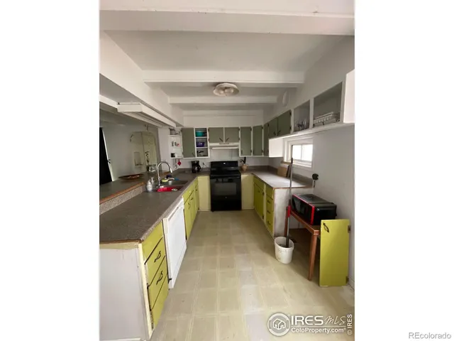 a view of a kitchen with furniture and a kitchen