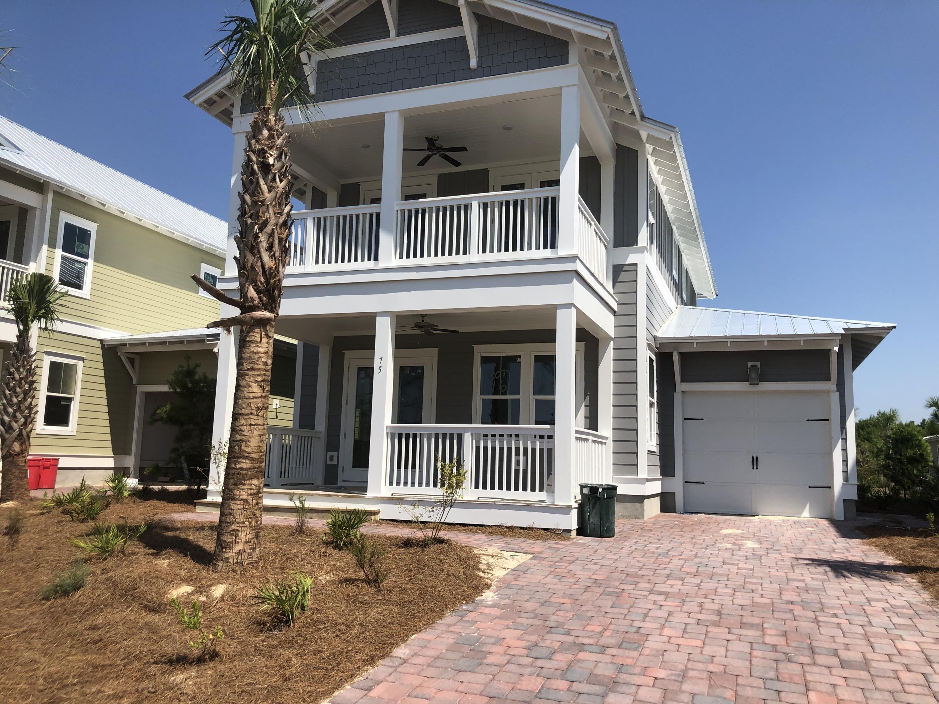 75 East Crabbing Hole Ln Inlet Beach Inlet Beach, FL 32461 - Photo 1 of 21 a front view of a house with a yard and garage