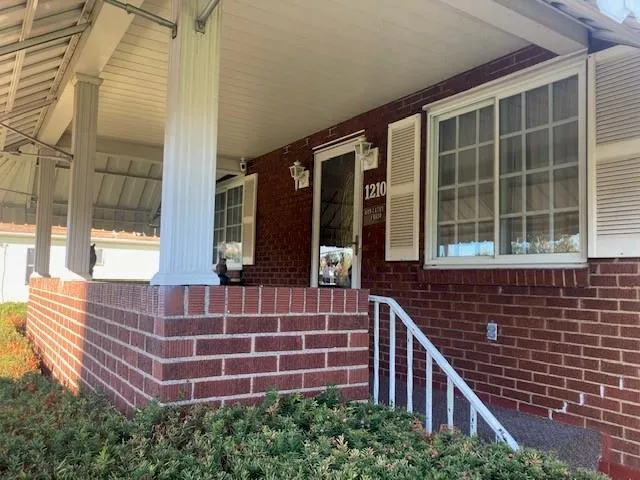 a view of front door of house with stairs