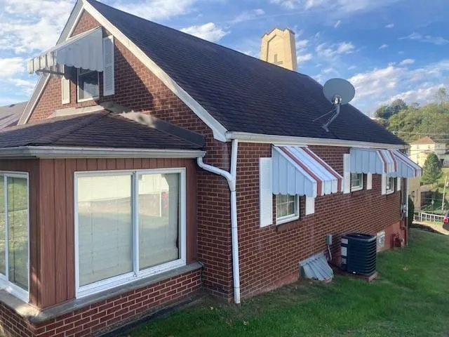 a view of a house with a backyard