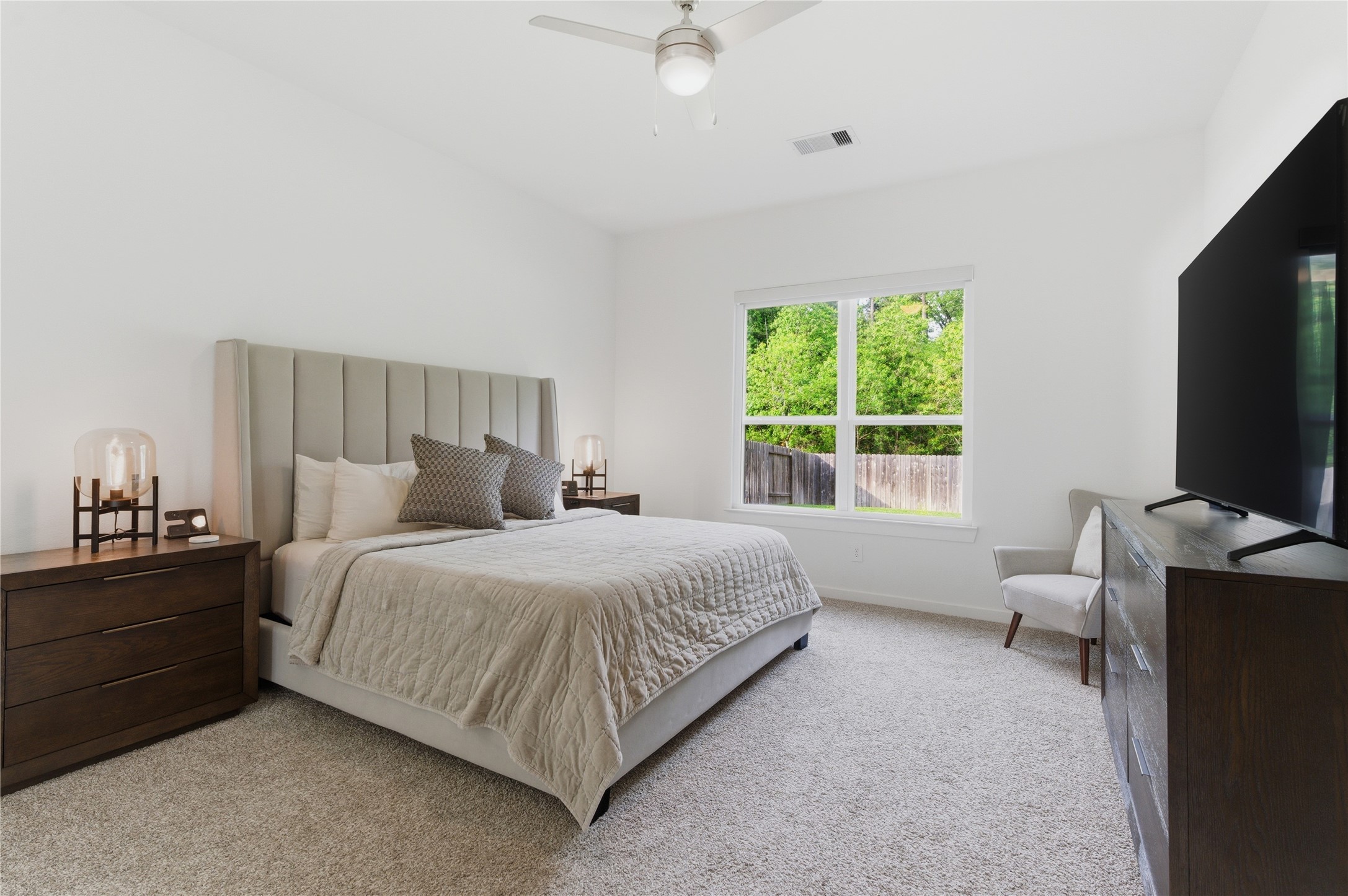 14108 Redfish Lake Conroe, TX 77384 - Photo 14 of 37 a bedroom with a bed and a flat screen tv