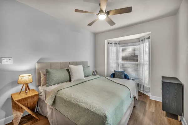 a bedroom with a bed and a chandelier