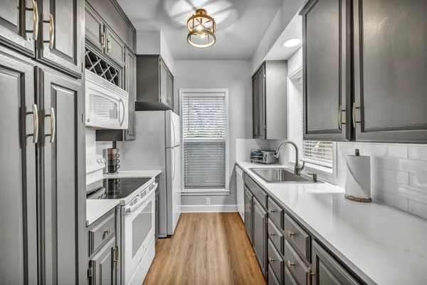 a kitchen with stainless steel appliances granite countertop a sink and stove