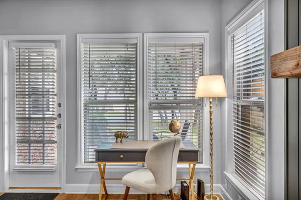 a view of a room with a window and a table chair