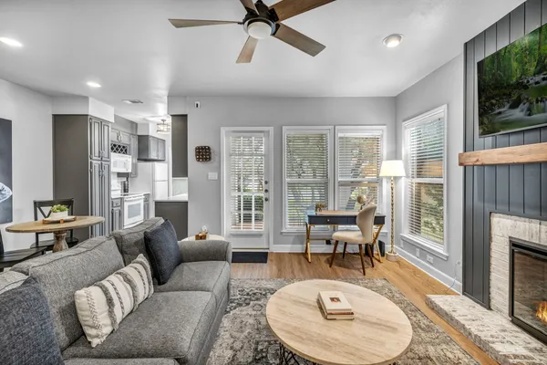 a living room with furniture a fireplace and a flat screen tv