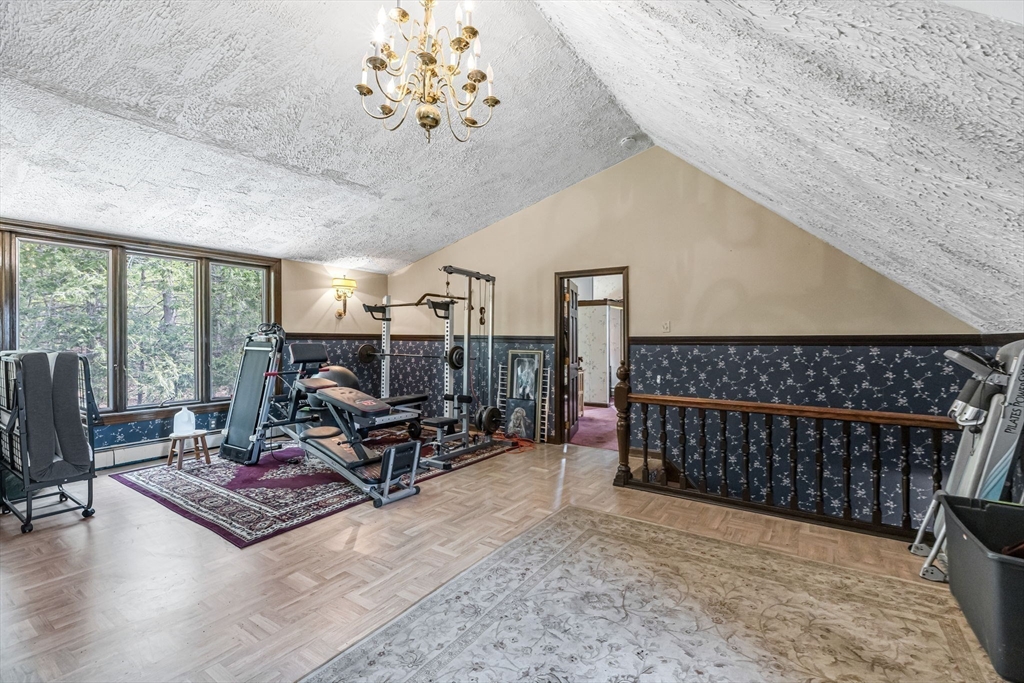163 South Monson Road Hampden, MA 01036 - Photo 16 of 34 a living room with furniture a rug and a chandelier
