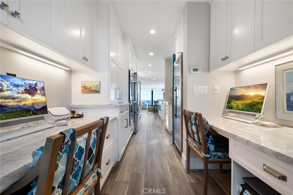 335 West I Street Encinitas, CA 92024 - Photo 10 of 23 a view of a kitchen with kitchen island stainless steel appliances wooden floor and living room view