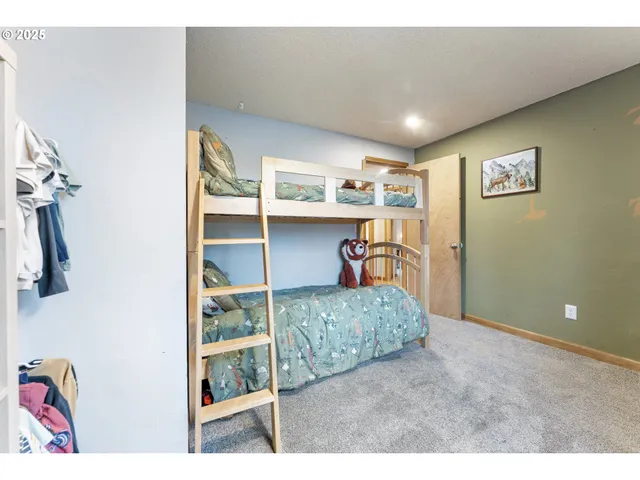 a bedroom with furniture and wooden floor