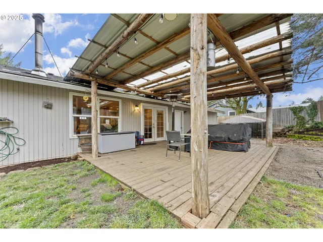 a backyard of a house with table and chairs