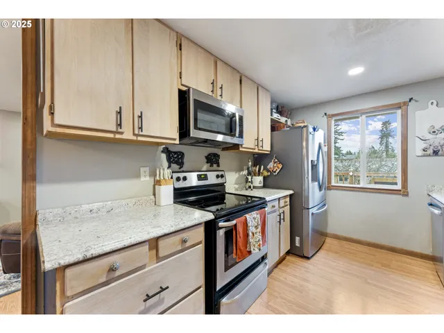 a kitchen with stainless steel appliances granite countertop a sink stove and cabinets