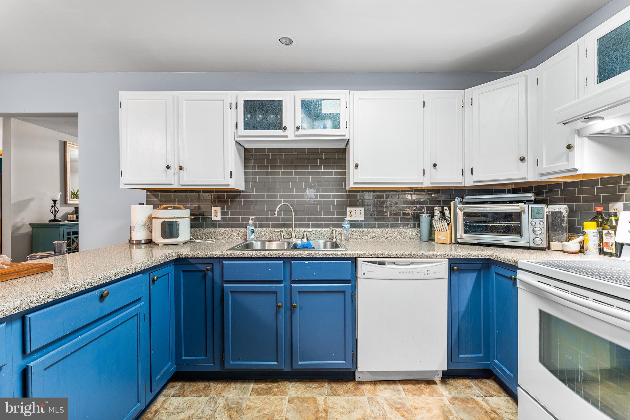 131 Quaker Road Pennsville, NJ 08070 - Photo 13 of 36 a kitchen with stainless steel appliances granite countertop a sink and cabinets with wooden floor