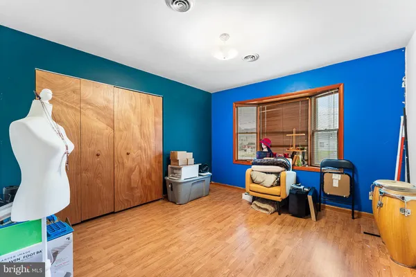 a bedroom with furniture and a large window