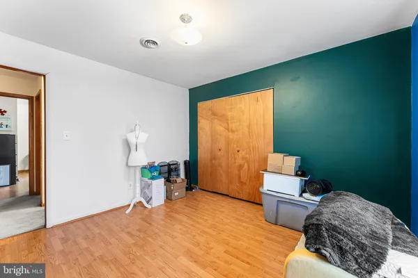 a bedroom with a bed and a dresser