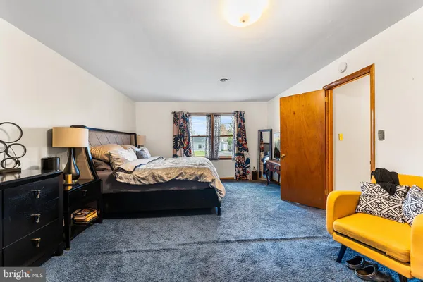 a bedroom with a bed and a couch