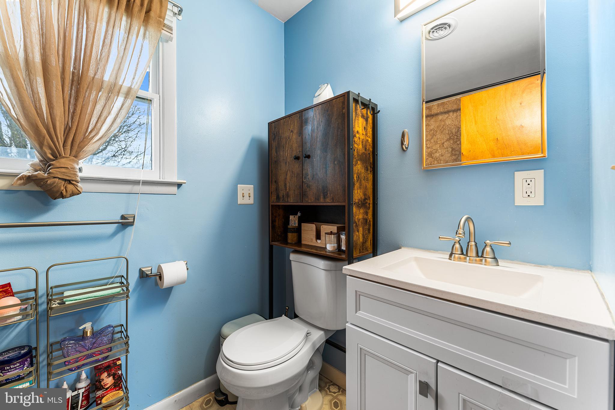 131 Quaker Road Pennsville, NJ 08070 - Photo 29 of 36 a bathroom with a sink a toilet and a mirror