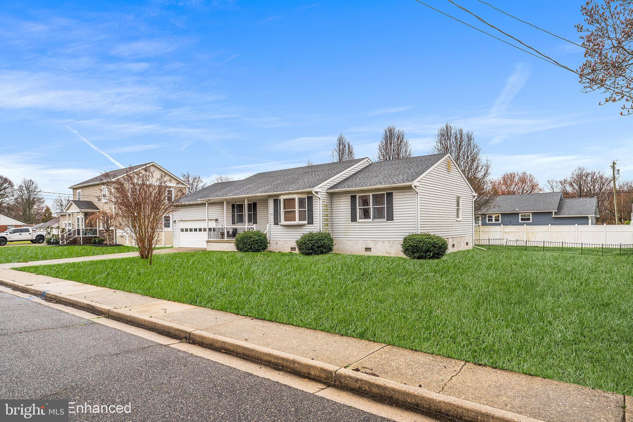 131 Quaker Road Pennsville, NJ 08070 - Photo 3 of 36 a view of a white house in front of a big yard with plants and large trees