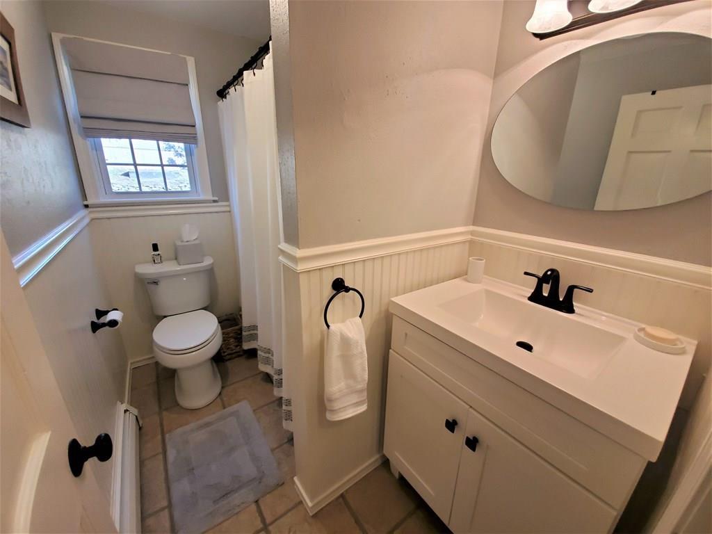 47 Blissful Lane Wareham, MA 02538 - Photo 11 of 24 a bathroom with a toilet sink and mirror