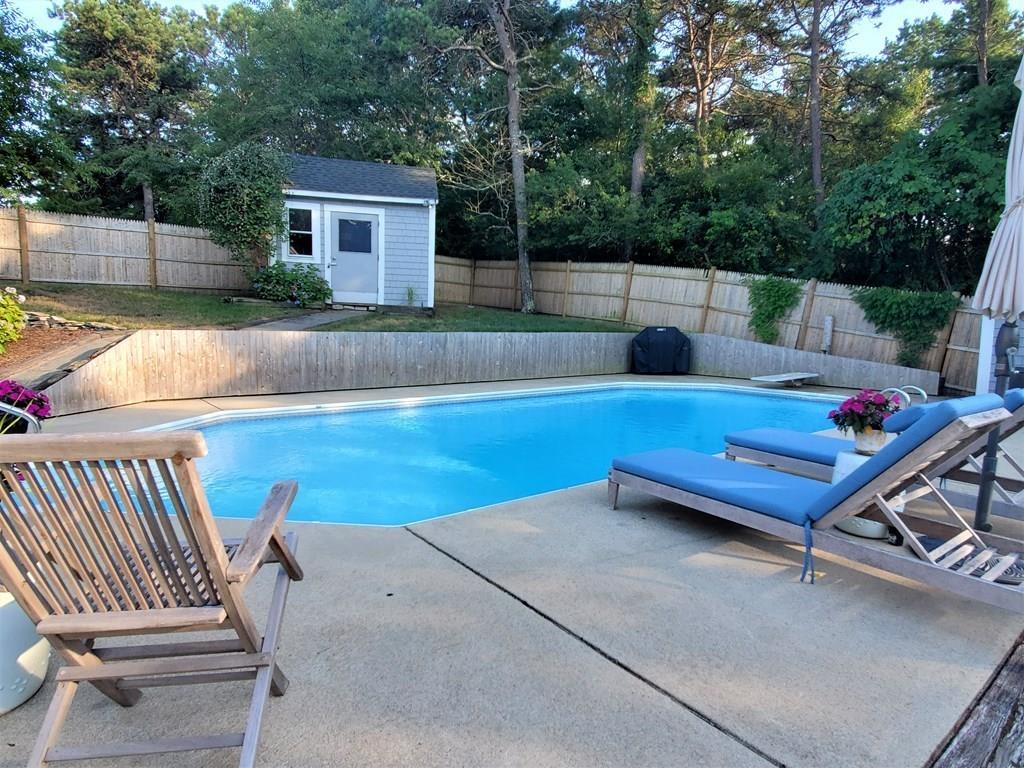 47 Blissful Lane Wareham, MA 02538 - Photo 15 of 24 a view of a backyard with a chair and potted plant