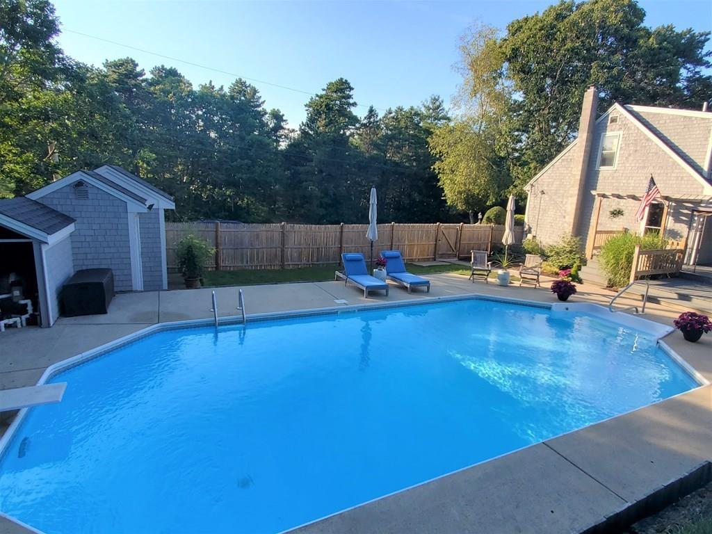 47 Blissful Lane Wareham, MA 02538 - Photo 18 of 24 a view of pool with lawn chairs and wooden fence