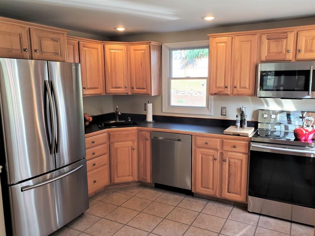 47 Blissful Lane Wareham, MA 02538 - Photo 3 of 24 a kitchen with granite countertop a refrigerator stove top oven and sink