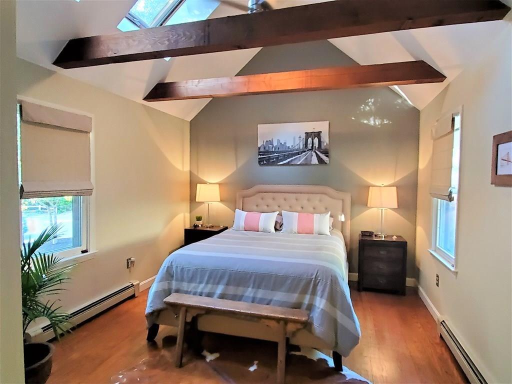 47 Blissful Lane Wareham, MA 02538 - Photo 9 of 24 a bedroom with a bed and a chandelier