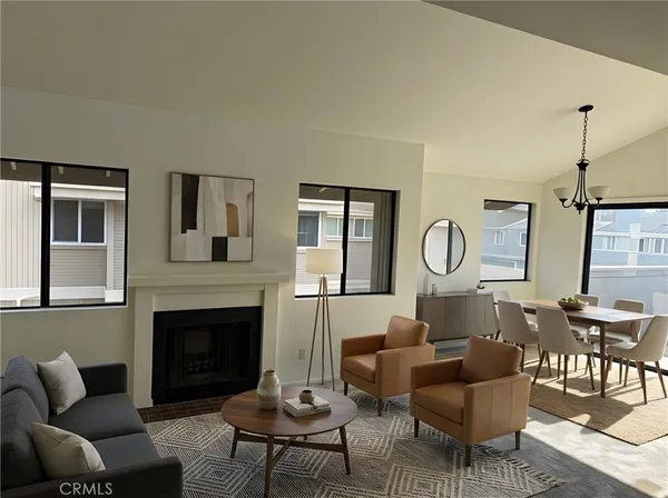 a living room with furniture a fireplace and a table