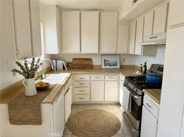 a kitchen with a sink stove and cabinets