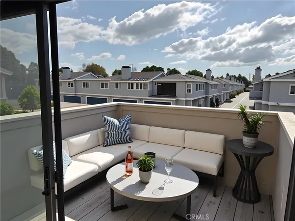 a view of a balcony with table and chairs