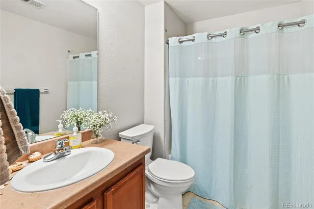 a bathroom with a sink toilet and mirror