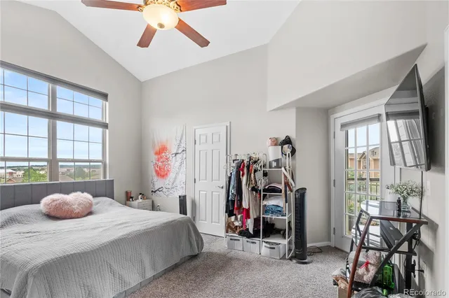 a bedroom with bed and a large window