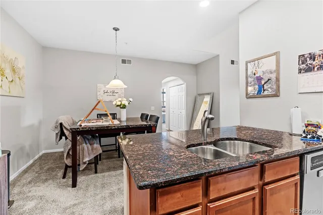 a kitchen with a sink a table and chairs