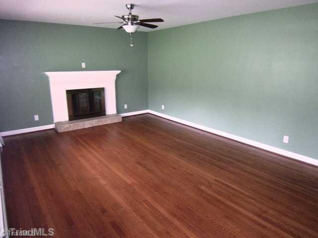 784 Motor Road Winston-Salem, NC 27105 - Photo 4 of 16 Living Room. Gleaming hardwoods and stucco surround wood burning fire place.